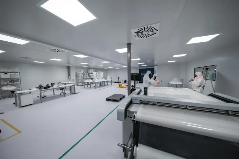 Cleanroom with technicians in protective suits